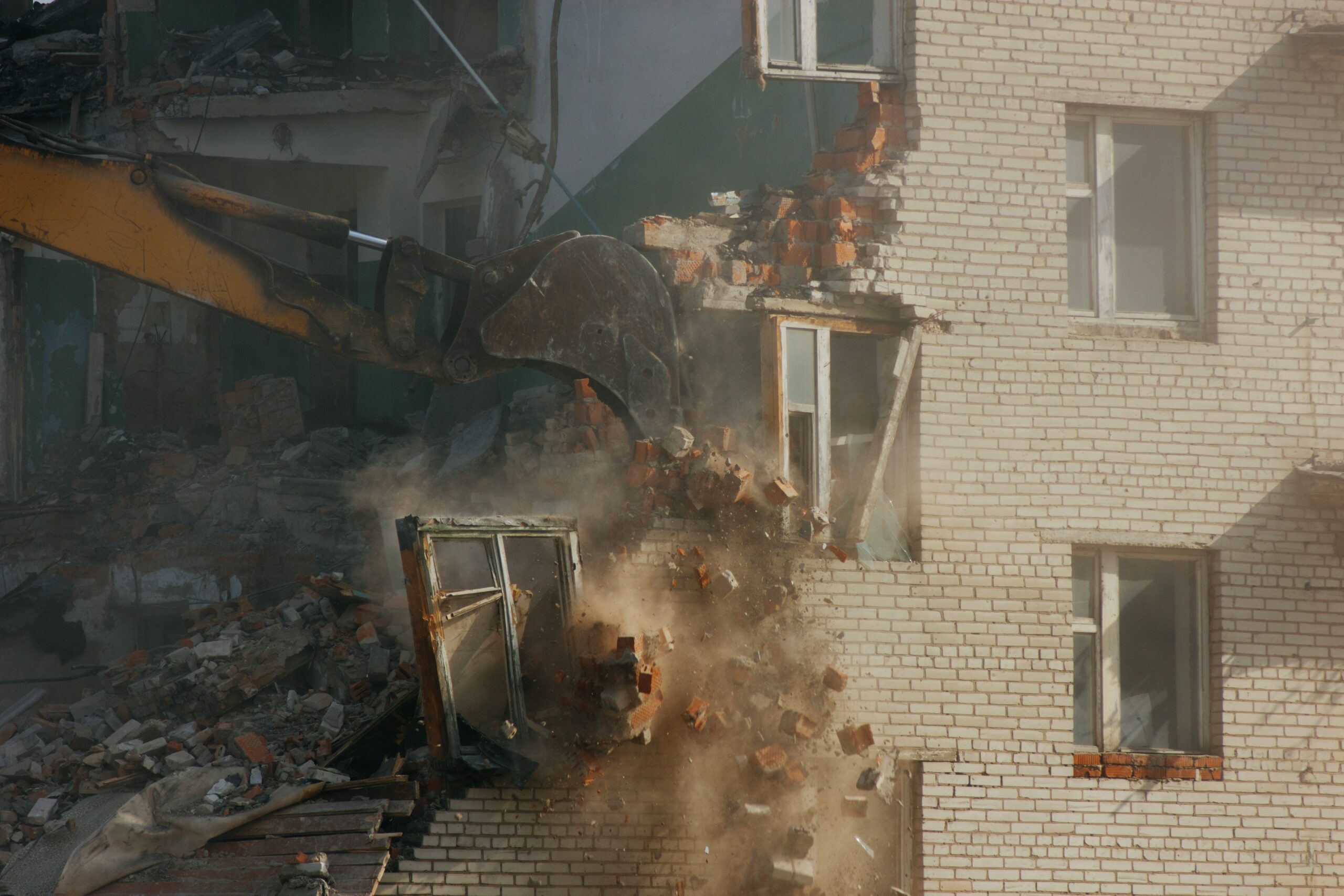 ruslan-khadyev-12Aqz3b3fxE-unsplash Bulldozer tearing apart a building